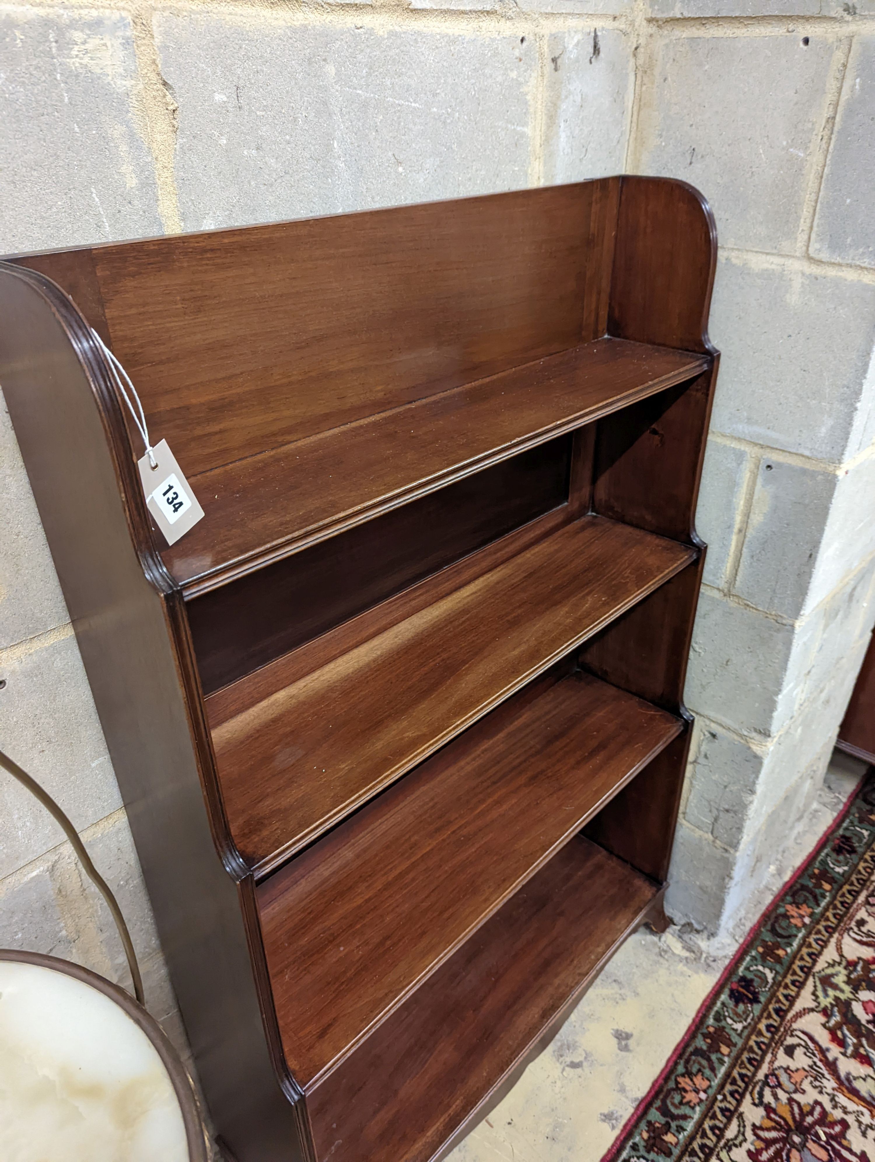 A George III style mahogany graduated open bookcase, width 77cm, depth 25cm, height 122cm